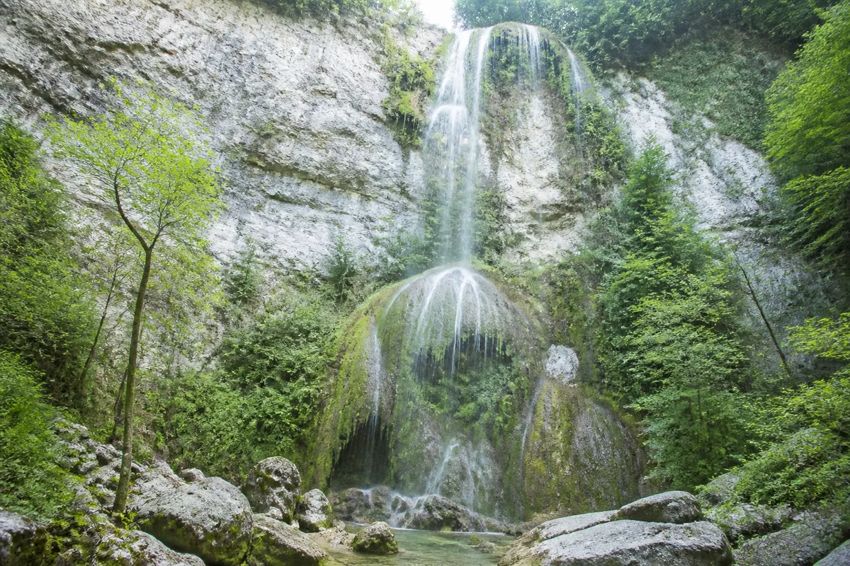 Chute d&rsquo;eau tombant sur une paroi calcaire couverte de mousse dans les gorges du Loup